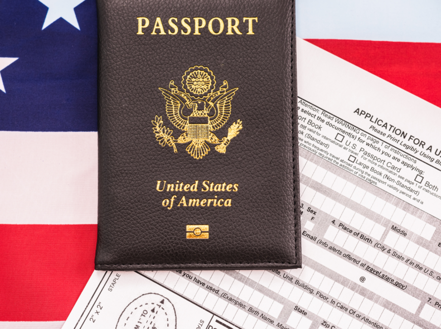 U.S. passport with application form on top of American flag background. Indicating EB2 NIW