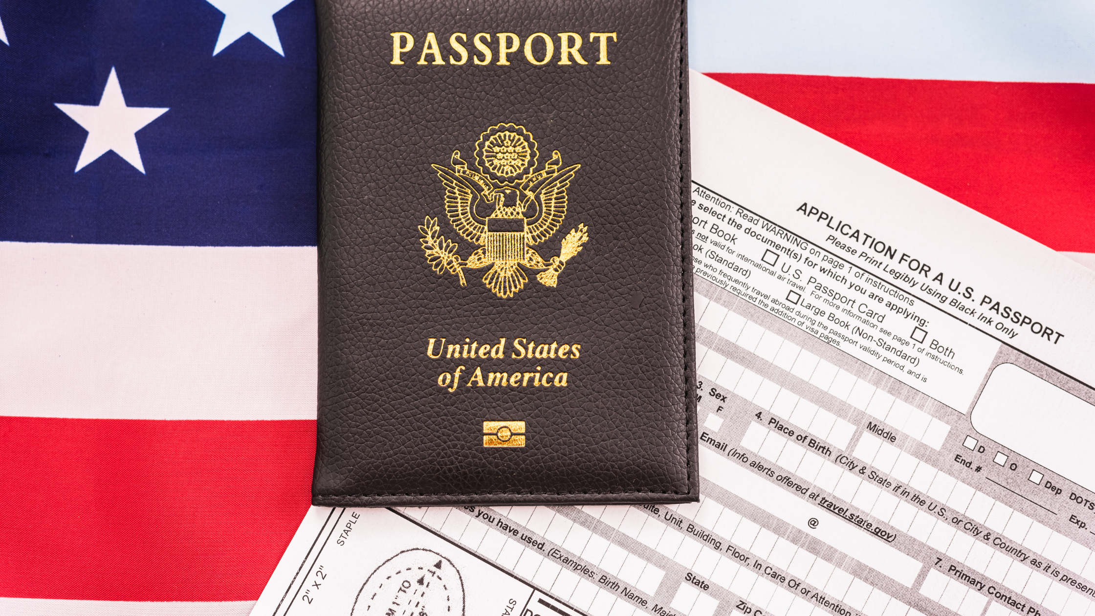U.S. passport with application form on top of American flag background. Indicating EB2 NIW