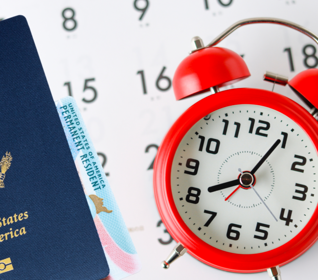 U.S. passport and green card beside a red alarm clock and calendar. Signifying Eb2 Processing Time